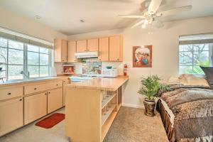 a kitchen with a counter and a bed in a room at Romantic Treetop Studio 30 Mi to Yosemite! in Coarsegold +17 photos