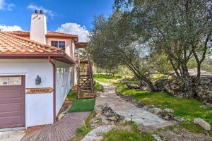 a house with a garage next to a path at Romantic Treetop Studio 30 Mi to Yosemite! in Coarsegold