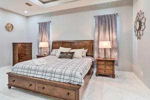 a bedroom with a bed with two nightstands and two lamps at St Pete Escape with Patio and Yard 6 Mi to Beach in St Petersburg