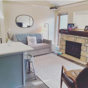 a living room with a couch and a fireplace at R & R Retreat Luxury Condo in Whistler