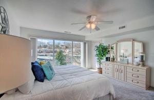 a bedroom with a bed and a large window at Lake of the Ozarks Views, Patio Regatta Bay Condo in Four Seasons
