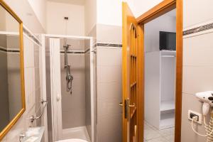 a bathroom with a shower and a toilet at Ada Hotel & Apartments in Giardini Naxos