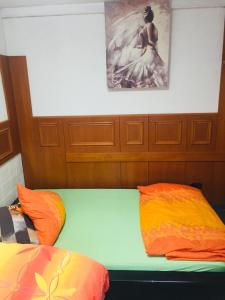 a room with two beds and a painting on the wall at Neo Event Hall room Neo1 in Staufenberg