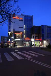 a building with a hotel in front of it at night at Hotel Pik in Mikołów