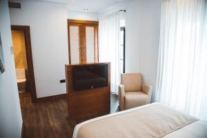 TV a/nebo společenská místnost v ubytování Ferreira Hostal Boutique