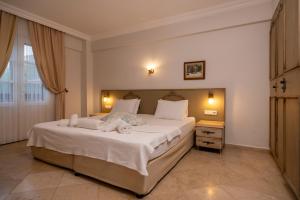 a bedroom with a large bed with towels on it at B&B Boutique Hotel in Dalyan