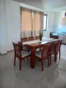 a wooden table and chairs in a room at Depto Temporario La Plata in La Plata +39 photos