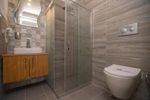 a bathroom with a toilet and a sink and a shower at B&B Boutique Hotel in Dalyan