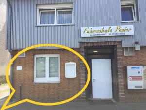 a building with a yellow circle in front of it at Gästezimmer I Neo1 in Staufenberg