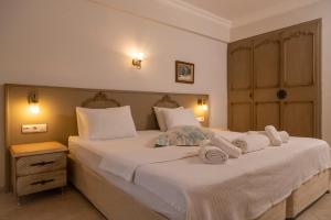 a bedroom with two beds with towels on them at B&B Boutique Hotel in Dalyan