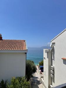 a view of the ocean from a building at Villa ARINA - Apartments 20 m from Beach, Tucepi in Tučepi +37 photos