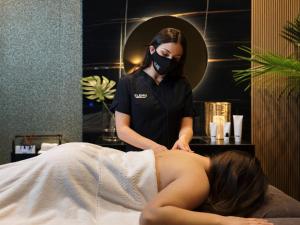 a woman getting a massage in a salon at Lure Hotel & Spa - Adults Only in Mellieħa