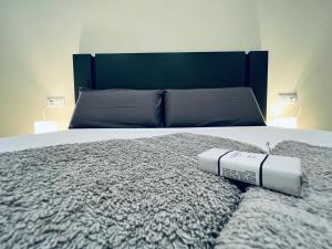 a bedroom with a large bed with a blanket and two lamps at PALM LIFE APARTMENT- Free Parking in Villareal