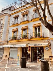 a building with windows and balconies on a street at Feel the Sherry experience2 by Musgo in Jerez de la Frontera
