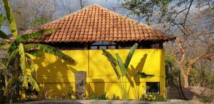 a yellow building with a tiled roof at San Simian Lodge in La Laguna