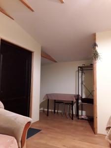 a dining room with a table in a room at AUSMAS in Strenči
