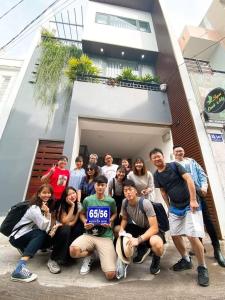 a group of people posing in front of a building at Triple-T Homestay in Vung Tau