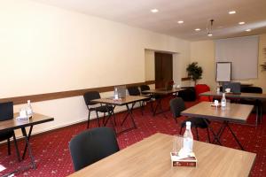 a classroom with tables and chairs and a whiteboard at Park Resort Aghveran in Aghveran