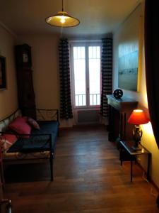 a living room with a couch and a window at Maison Haute in Moux-en-Morvan