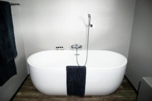
a white bath tub sitting next to a white sink at Grey Goose Game Lodge in Newcastle

