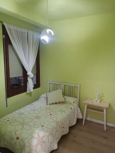 a bedroom with a bed and a window and a table at Casa Serral in Deltebre