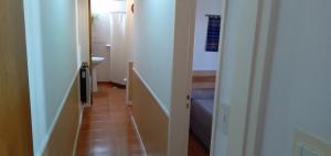 a hallway with a hallway leading to a bathroom at La Colonial Cabañas in Villa Cura Brochero +41 photos