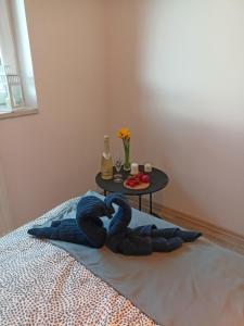 een bed met een blauwe deken en een tafel bij Apartament z Sauna i Jacuzzi in Radom