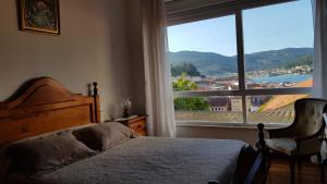 Ліжко або ліжка в номері En Muros, céntrico, amplio, luminoso, vistas al mar