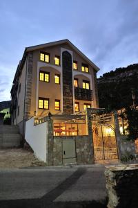a large building with a gate in front of it at Hotel Blagaj Mostar in Blagaj