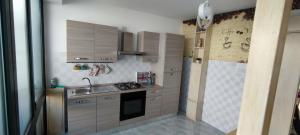 a small kitchen with a sink and a stove at Emily House in Porto Cesareo