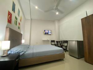 Llit o llits en una habitació de CasaBlanca ApartaEstudios