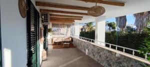 a balcony of a house with a couch on it at Emily House in Porto Cesareo