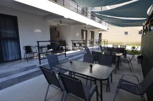 a group of tables and chairs on a patio at Vila 69 in Costinesti