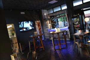 a bar with tables and stools in a room at Hotel Sereno in Sestri Levante