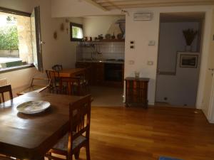 a kitchen and dining room with a table and chairs at Nido del Tadini in Lovere +12 photos