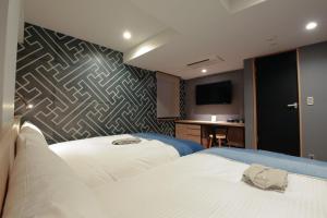 Rúm í herbergi á Asakusa Kokono Club Hotel