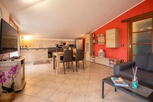 a living room with a table and a kitchen at My Baby House in Alghero