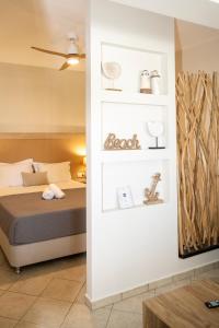 a bedroom with a bed and white shelves at Aegean Suite in Azolimnos