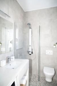 a bathroom with a shower and a sink and a toilet at Aegean Suite in Azolimnos Syros
