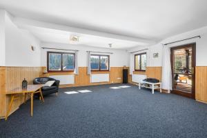an empty room with a desk and a table at Penzion Petra, Harrachov in Harrachov