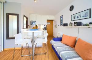 ein Wohnzimmer mit einem Sofa, einem Tisch und Stühlen in der Unterkunft Studio Apartment Vesna in Krk