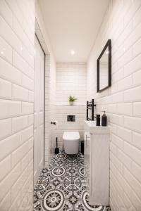 a bathroom with a toilet and a tiled floor at The Station in Poulton le Fylde