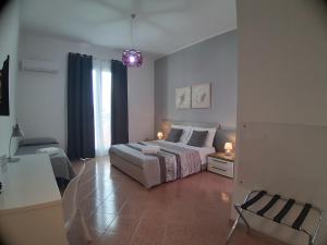 a bedroom with a bed and a table in a room at B&B Costa Sicula in Avola +27 photos