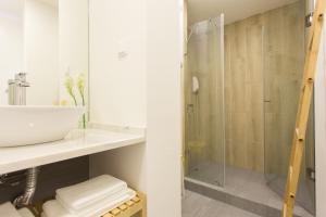 a bathroom with a sink and a shower at Amalia Studios in Lisbon