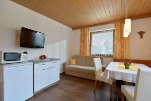 a small living room with a couch and a table at Landhaus Stefanie in Mayrhofen