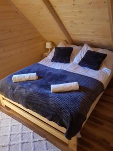 a bed in a attic with two pillows on it at Chata Rafusa pod Śnieżnikiem in Stronie Śląskie