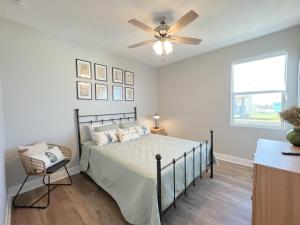 a bedroom with a bed with a ceiling fan at Crystal Blue home in Crystal Beach