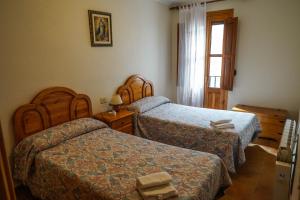 a hotel room with two beds and a window at CASA MERCEDES-PUERTOMINGALVO in Puertomingalvo +32 photos