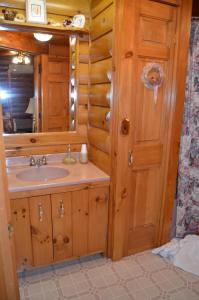 a bathroom with a sink and a mirror at Serenity On The Lake in Auburn