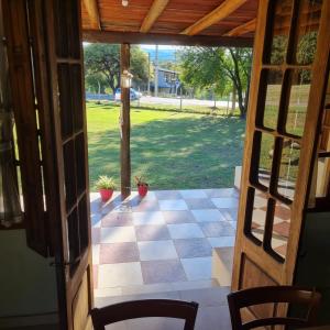 an open door to a porch with a checkered floor at Las Brisas casas de campo un lugar para soñar in San Antonio de Arredondo